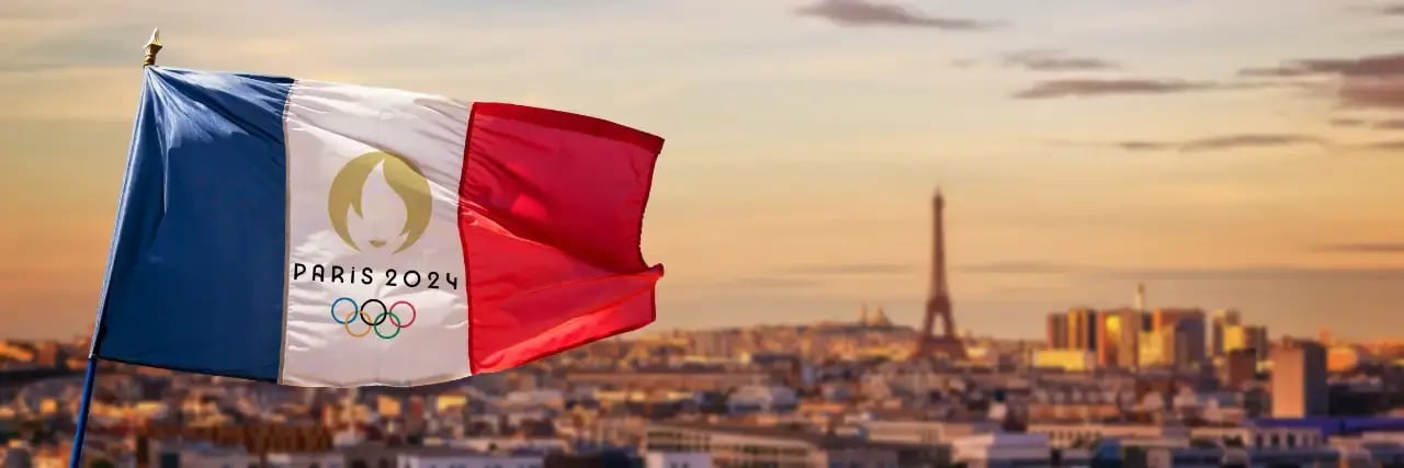 paris 2024 olympics flag flies over paris skyline